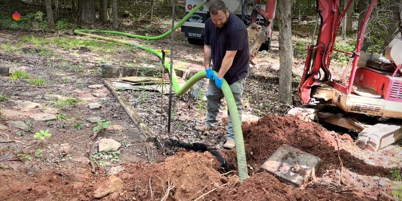 A mini excavator on a septic job beside a house