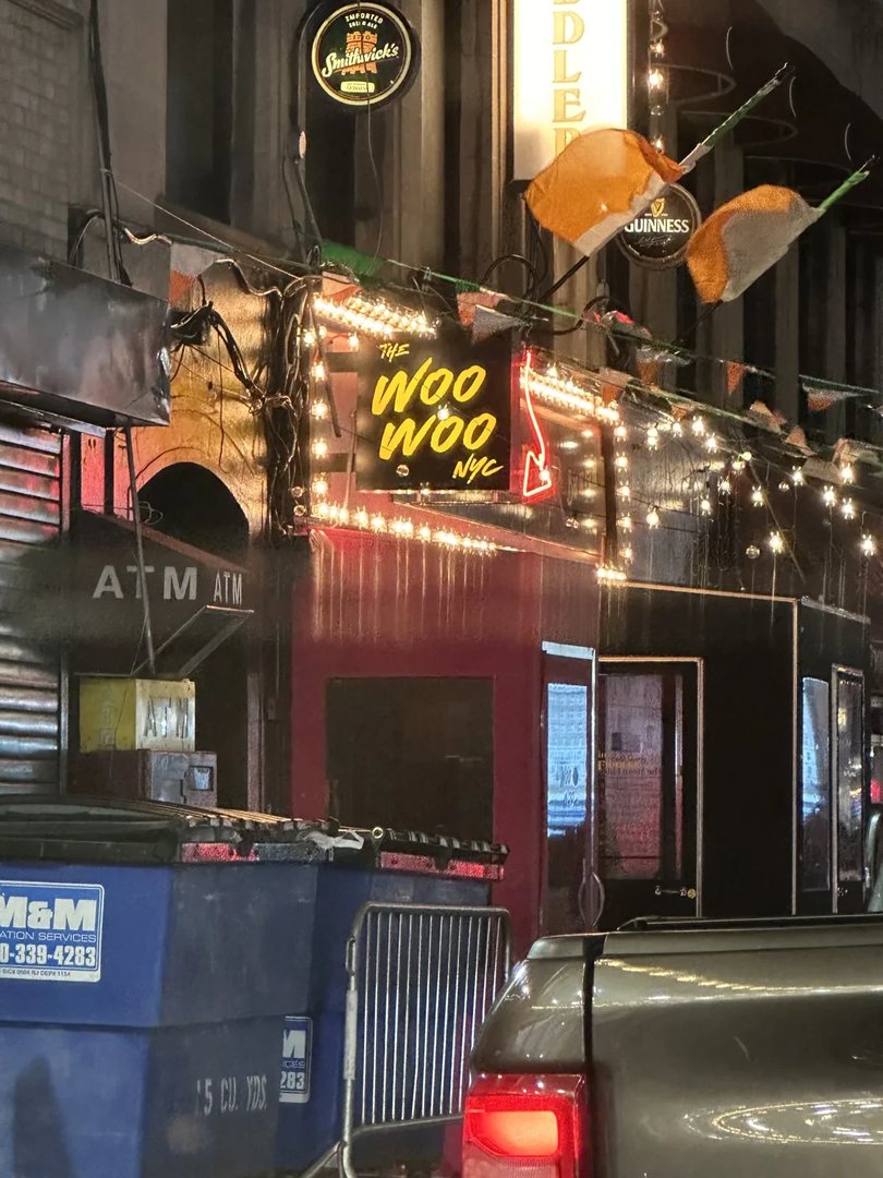 A New York street at night with lit signs, photographed during an NYIA assignment