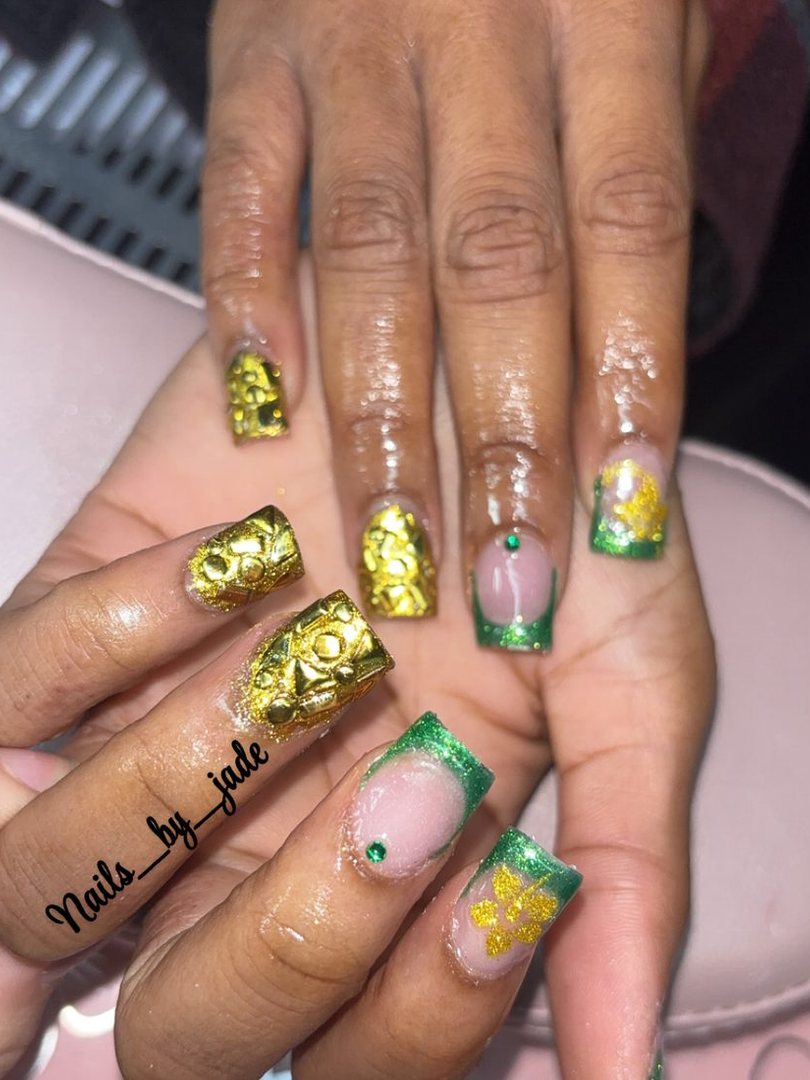 A set of green and gold nails with painted flowers