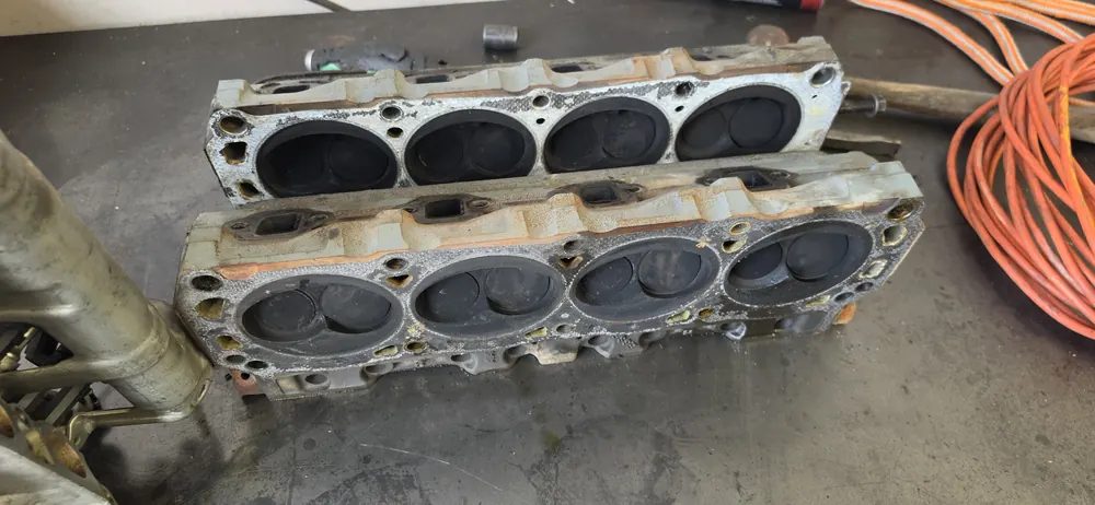 Two cylinder heads on the bench, combustion side up, during a Supercanic engine overhaul