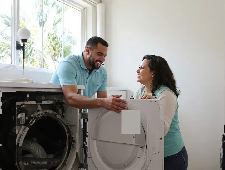 Tech going over a dryer repair with a homeowner in a bright Broward laundry room