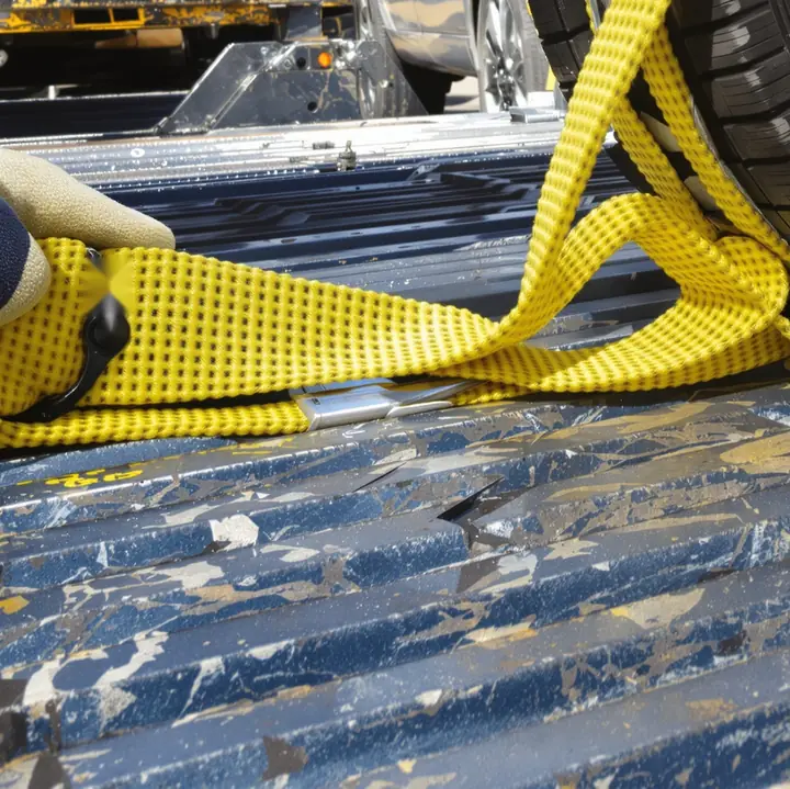 Yellow wheel strap pulled tight on a carrier deck