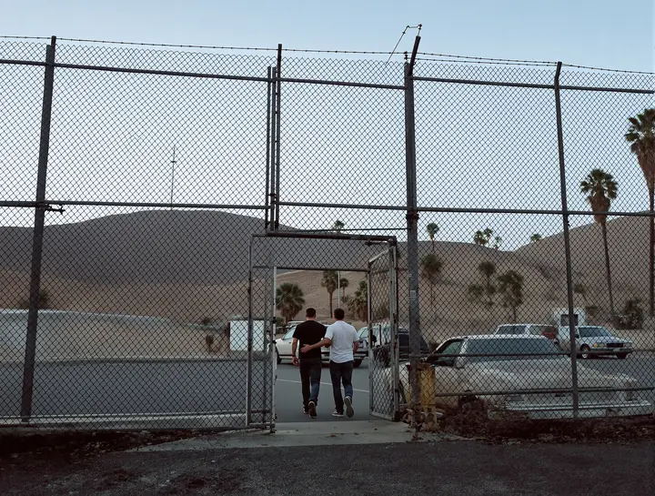 A father meeting his son outside the jail gate at dawn