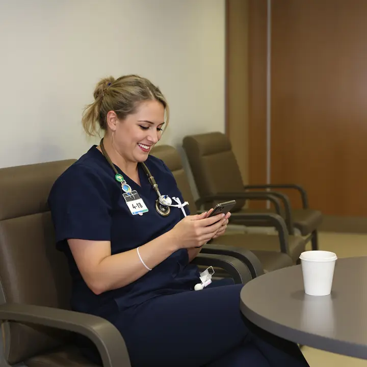 A nurse on break in a Jackson hospital checking her phone