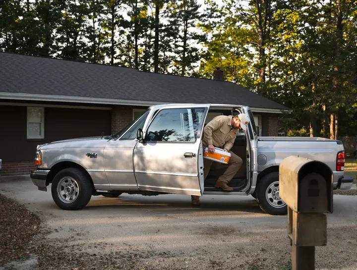 A man getting into his pickup in a Madison County driveway before work