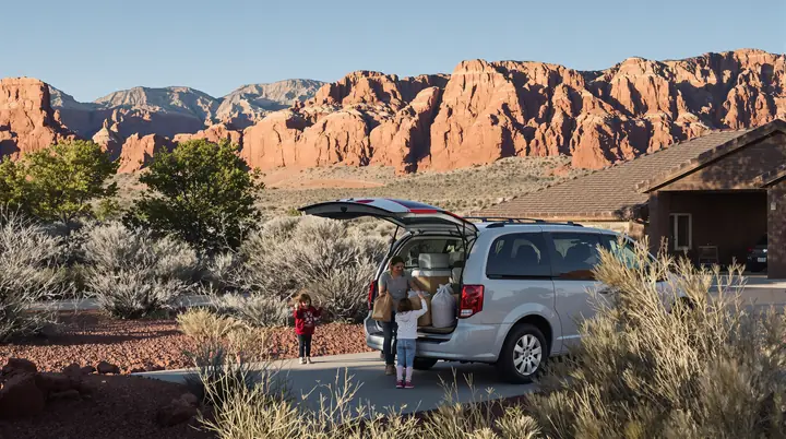 A mother and daughter loading groceries into their minivan in Fruita