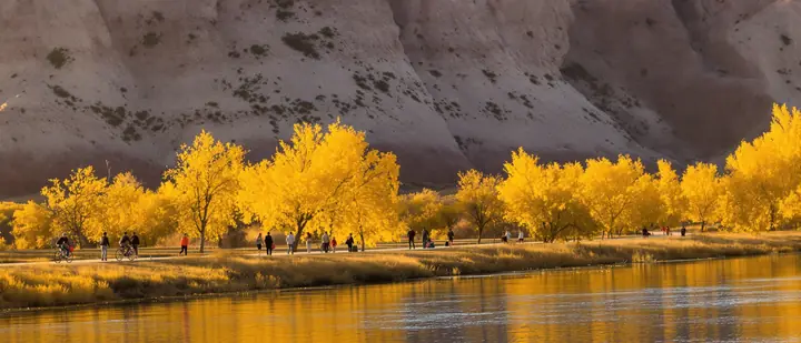 People walking the Colorado River trail in Grand Junction at golden hour
