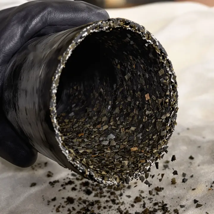 Flaky black creosote inside a section of stove pipe