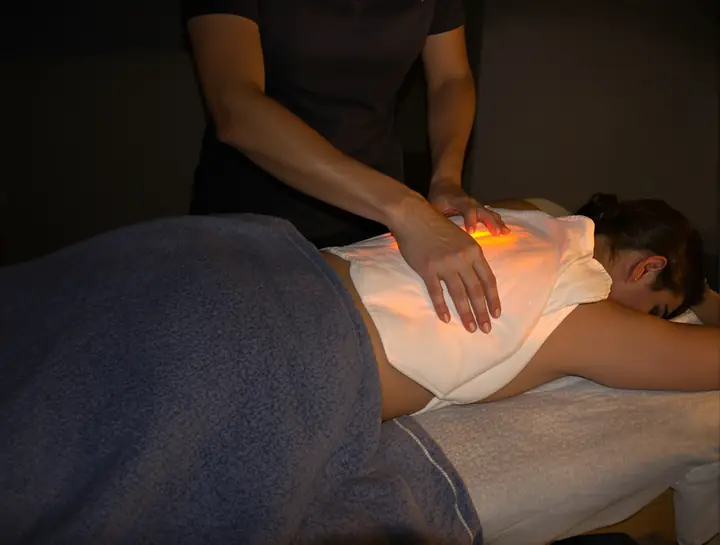 Warm heat pack on a patient's back in a quiet treatment room