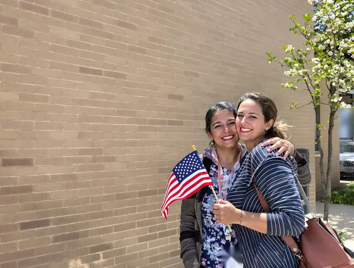 A new citizen hugging her daughter after her oath ceremony