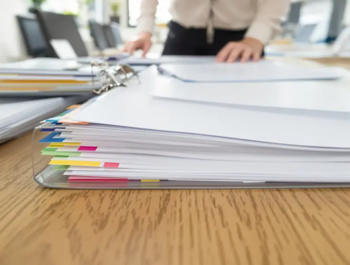 A paralegal assembling a tabbed application packet