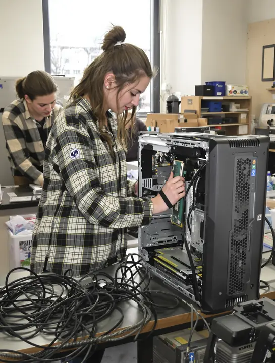 IT student reseats memory in a desktop computer