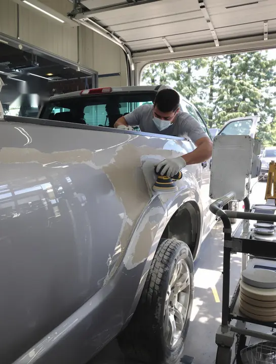 Body tech block sanding filler on a silver pickup quarter panel