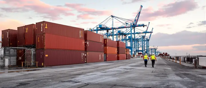 Longshoremen walking the dock at the port at sunrise