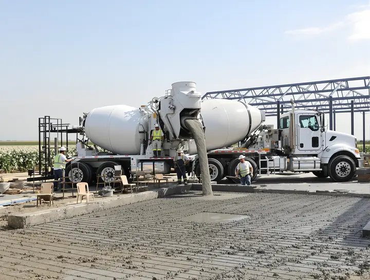 Ready mix truck pouring into formed rebar for a shop slab in Shallowater