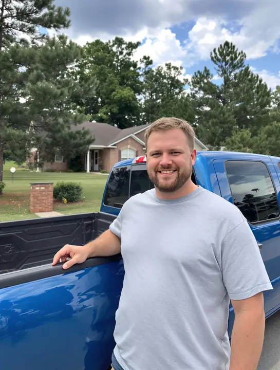 Client next to the used pickup he bought after fixing two report errors