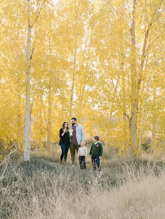 A family among golden cottonwoods in the Rio Grande bosque