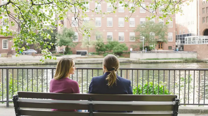 Talking with a client on a bench along the Chattahoochee Riverwalk