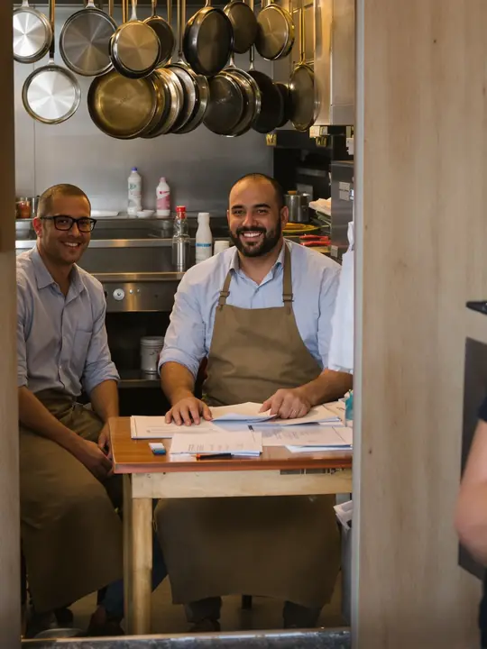 Going over quotes with a taqueria owner in his back office