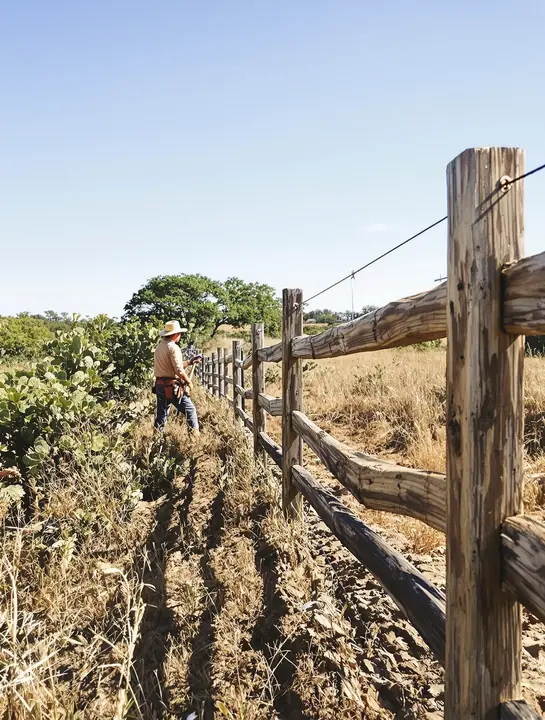 Three rail ranch fence along a pasture near Wimberley