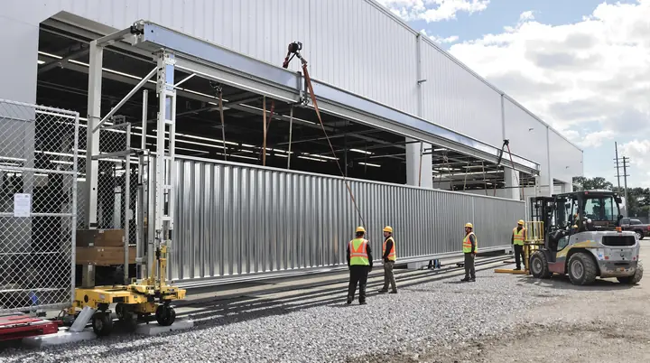 Crew setting a cantilever slide gate at a yard off the Joe Fulton Corridor