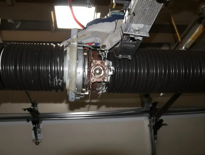 Snapped torsion spring on the shaft above a door