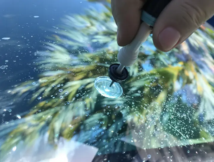 Resin injector set over a bullseye rock chip