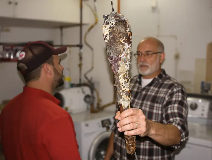 Showing a homeowner a worn out anode rod, Wheaton