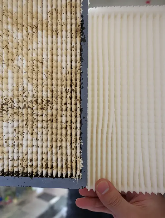 Clogged air filter next to a clean new one
