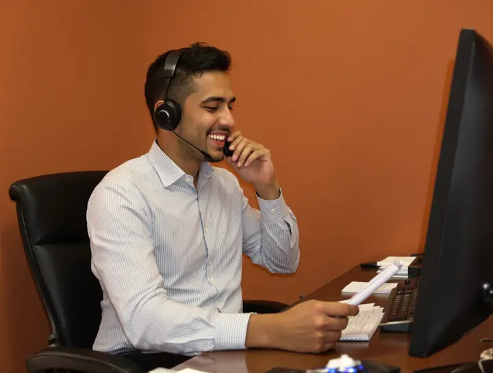 Our paralegal Luis on a call with a client in Spanish