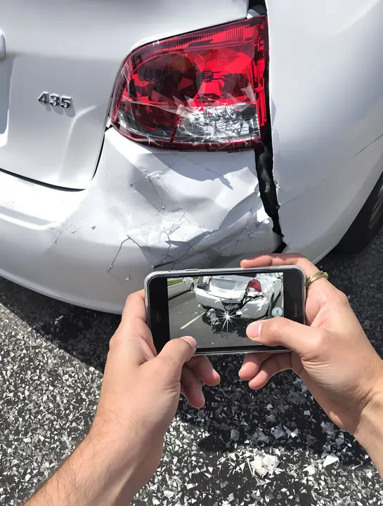 Taking a photo of a cracked tail light after a crash