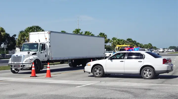 Box truck and sedan stopped after a crash on the expressway