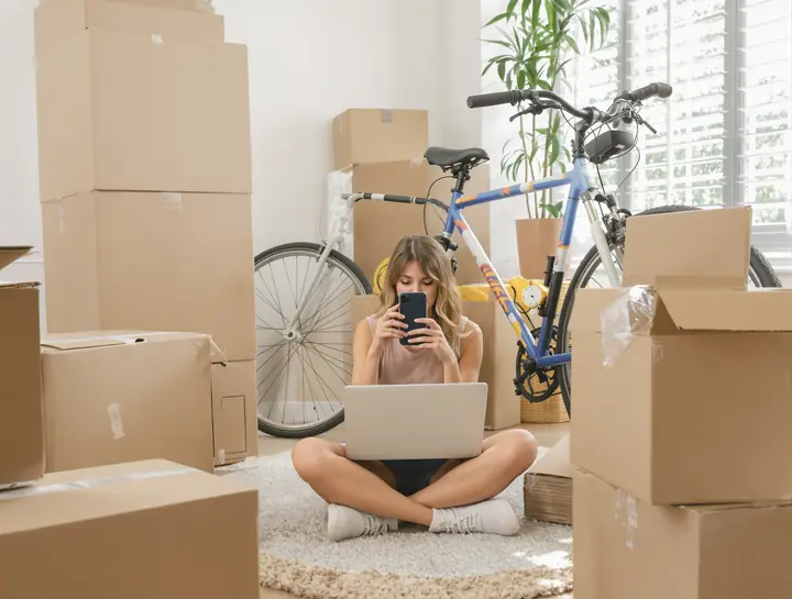 Renter filming her belongings among moving boxes for a home inventory
