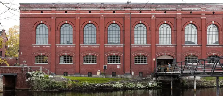 A woodworking shop inside a converted brick mill by the river