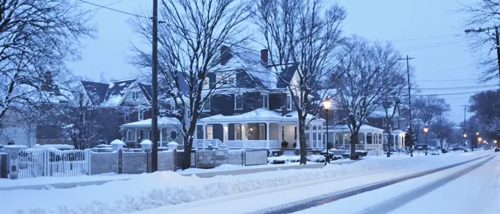 Snowy Syracuse street of old porch front houses at first light