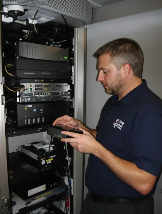 Tech checking the backup drive and storage box in a law office closet