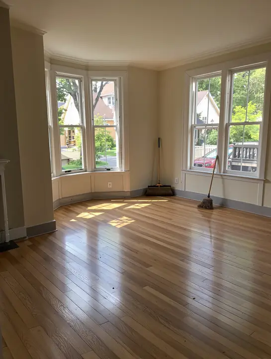 An empty living room swept clean after the cleanout