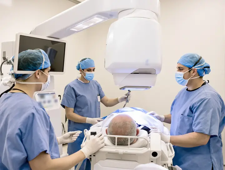 Laser suite with the surgical team around a patient