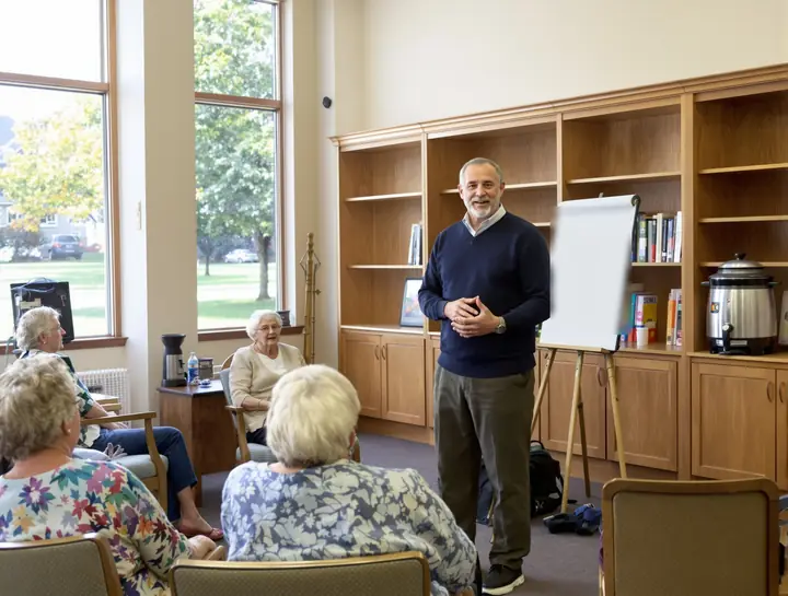 Glenn answering questions for seniors in a retirement community library