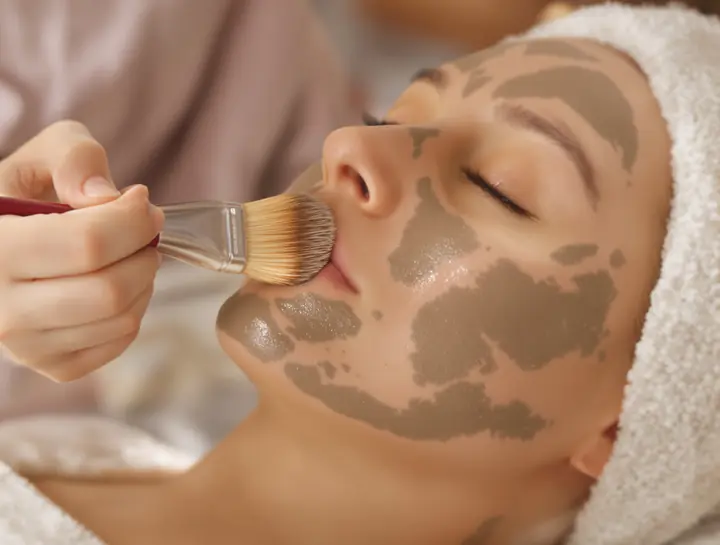 Clay mask being brushed on