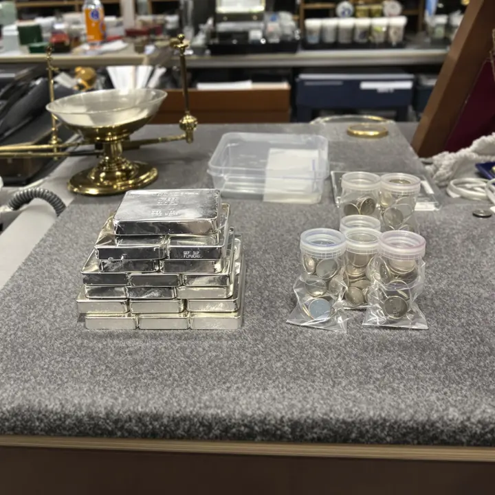 Silver bars and tubes of rounds on the back room felt