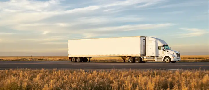 Moving truck crossing the Kansas prairie at sunset