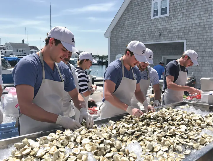 Summer crew shucking oysters at a shack on the coast