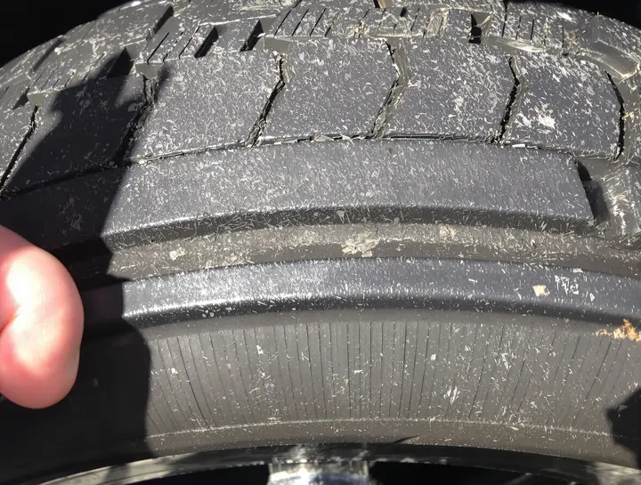 Worn tire tread down near the wear bar