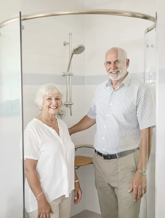 Installer showing a Sarasota couple how the fold down shower seat works