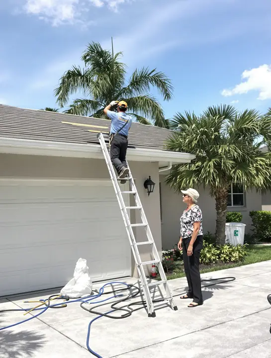 A roofer showing a homeowner her new roof edge