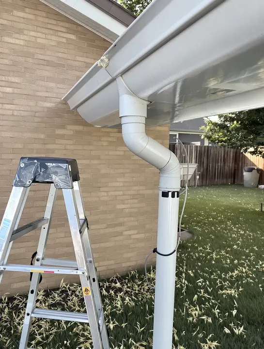 Checking a gutter and downspout for hail dents