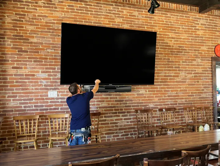 Mounting a big TV on the brick wall of a small town bar and grill