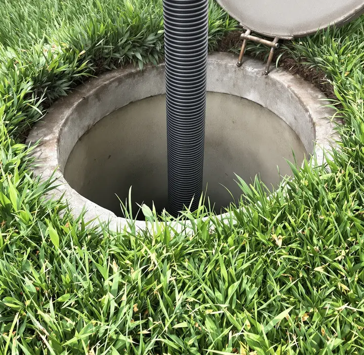 Suction hose in an open septic tank