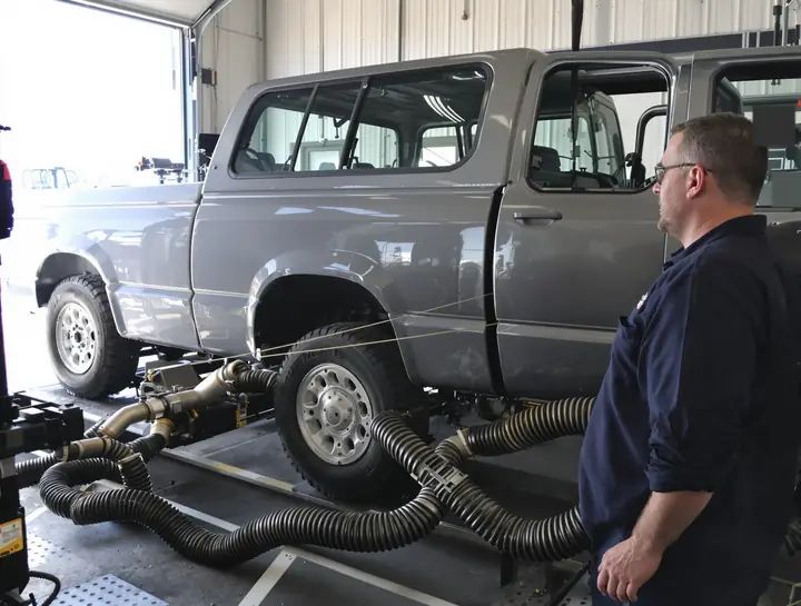 Older pickup on the dyno rollers with the tailpipe probe in